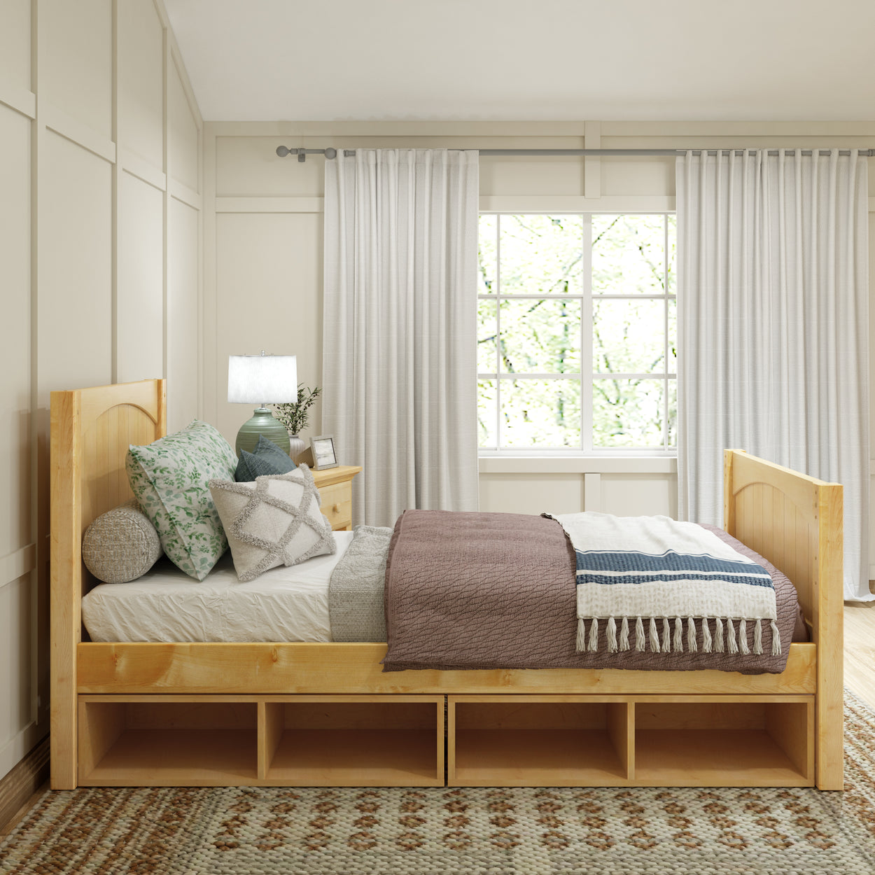 Cozy bedroom with wooden bed frame and decorative pillows near large window with white curtains.