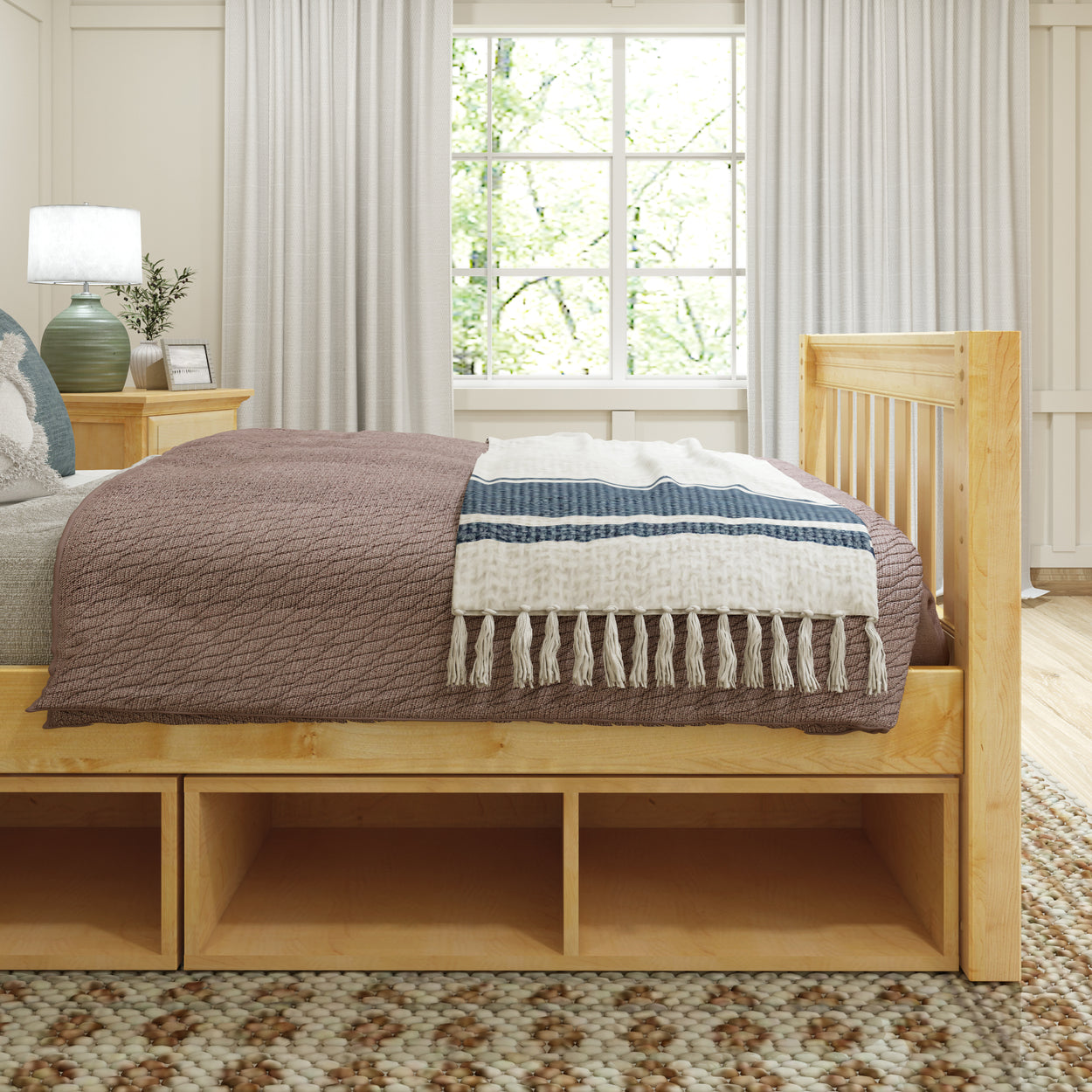 Modern bedroom with wooden bed frame, cozy brown and white bedding, and natural light streaming through the windows.