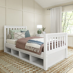 Cozy bedroom with a white wooden daybed featuring storage drawers, decorative pillows, and a warm brown blanket, near a window and a lamp on a side table.