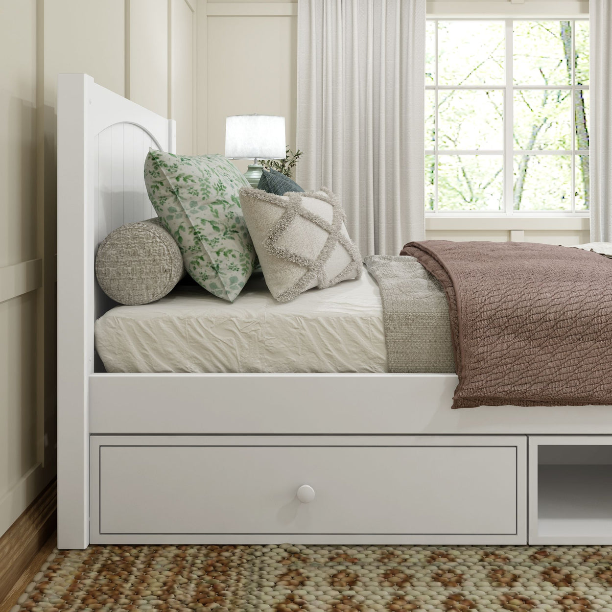 Modern cozy bedroom with a white bed frame, decorative pillows, and a soft brown blanket.