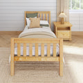 Cozy minimalist bedroom with natural wood bed frame, woven throw pillows, bedside nightstand and lamp, shiplap wall