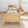 Light airy farmhouse bedroom with natural wood twin bed frame, neutral bedding, woven accent pillow, nightstand lamp and shiplap wall