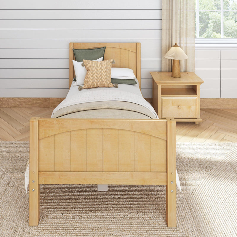Light airy farmhouse bedroom with natural wood twin bed frame, neutral bedding, woven accent pillow, nightstand lamp and shiplap wall