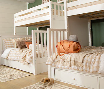 Kids solid wood loft bed with built-in storage drawers, ladder and study desk in natural wood finish — space-saving children's bedroom furniture