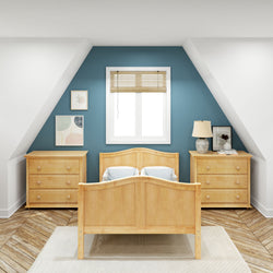 Cozy attic bedroom with wooden furniture, blue accent wall, and natural light.