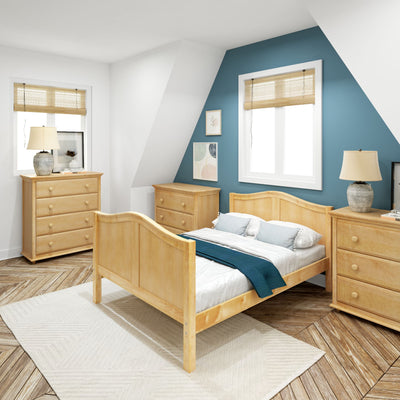 Cozy bedroom with wooden bed and dressers, blue accent wall, and natural light.