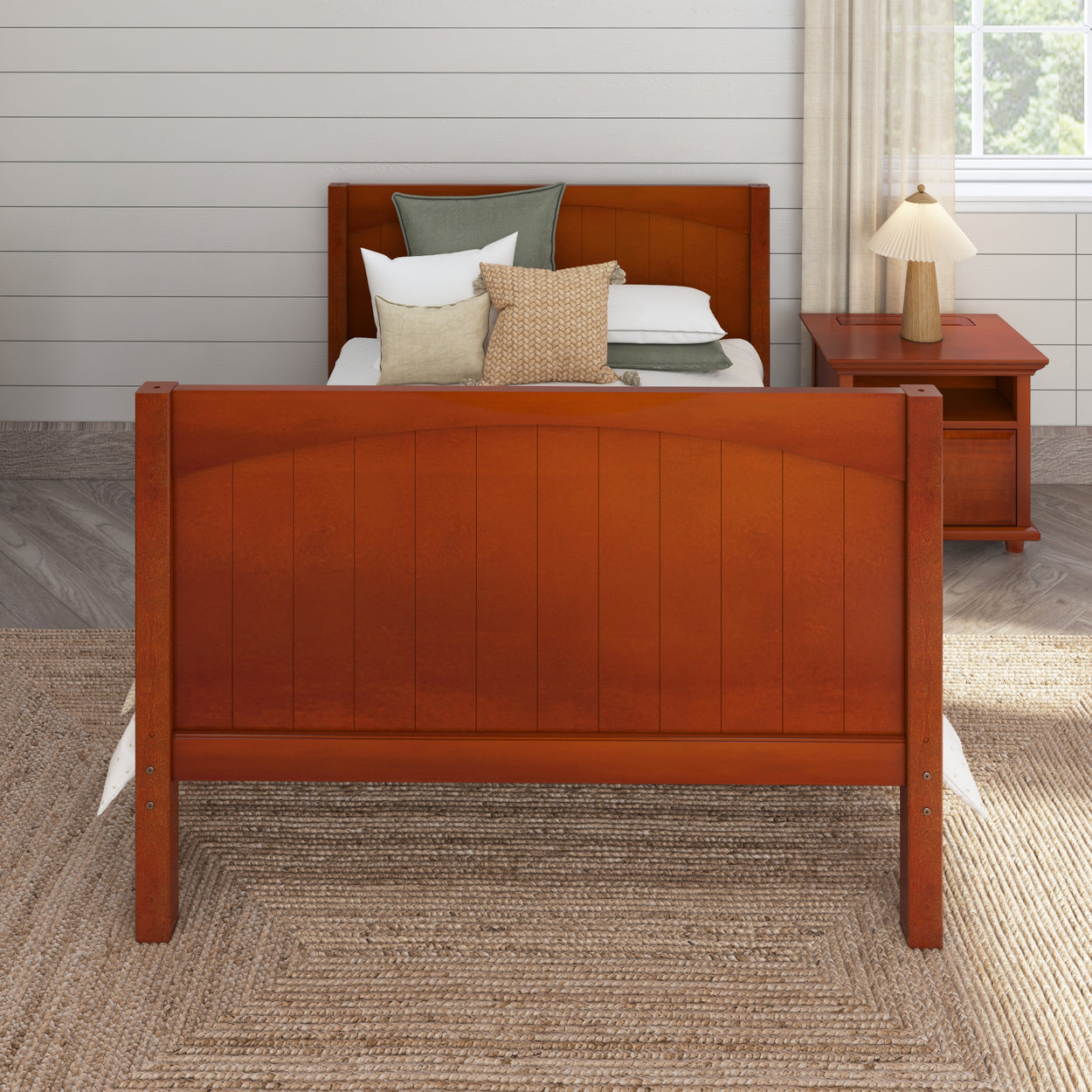 Wooden bed frame with comfortable pillows and nightstand in cozy bedroom setting.
