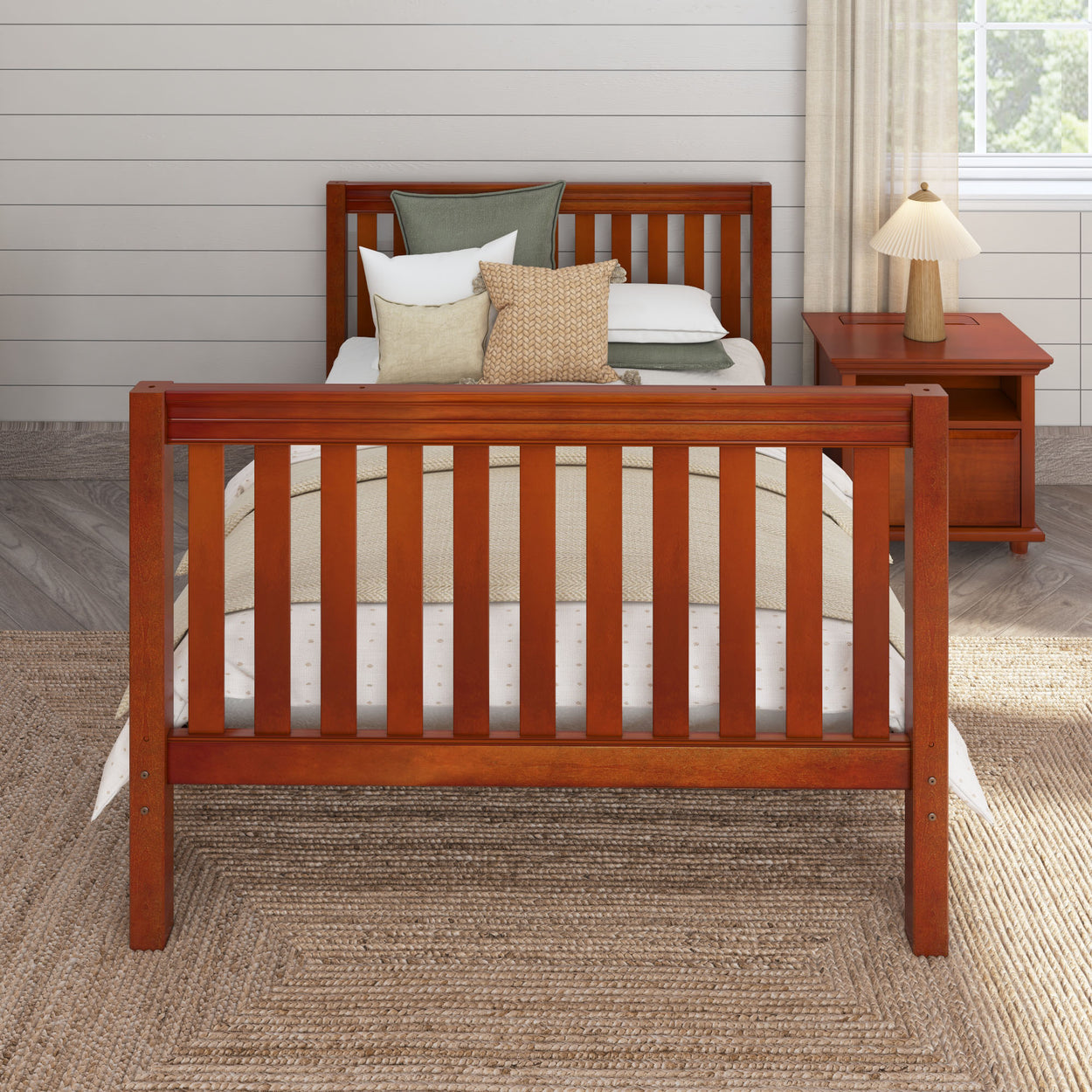 Wooden bed with clean lines and neutral bedding in a cozy bedroom setting with side table and lamp.