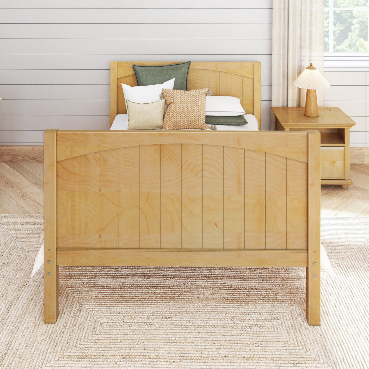 Wooden bed with cozy pillows in a modern bedroom featuring a nightstand and neutral decor.