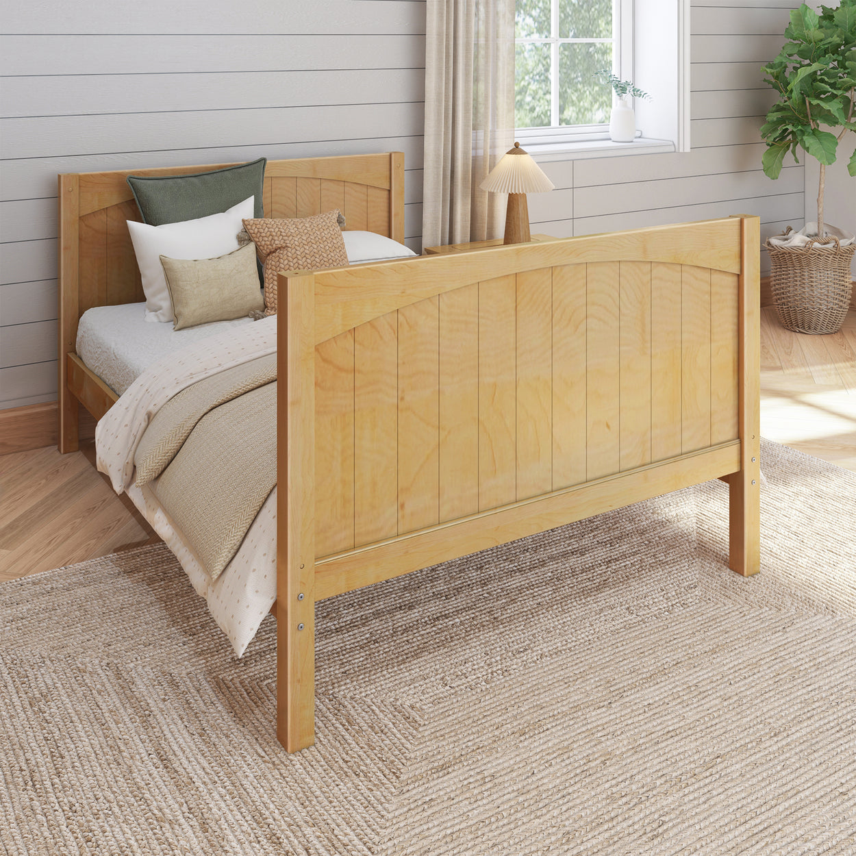 Wooden bed frame with cozy pillows and blankets in a stylish bedroom setting.