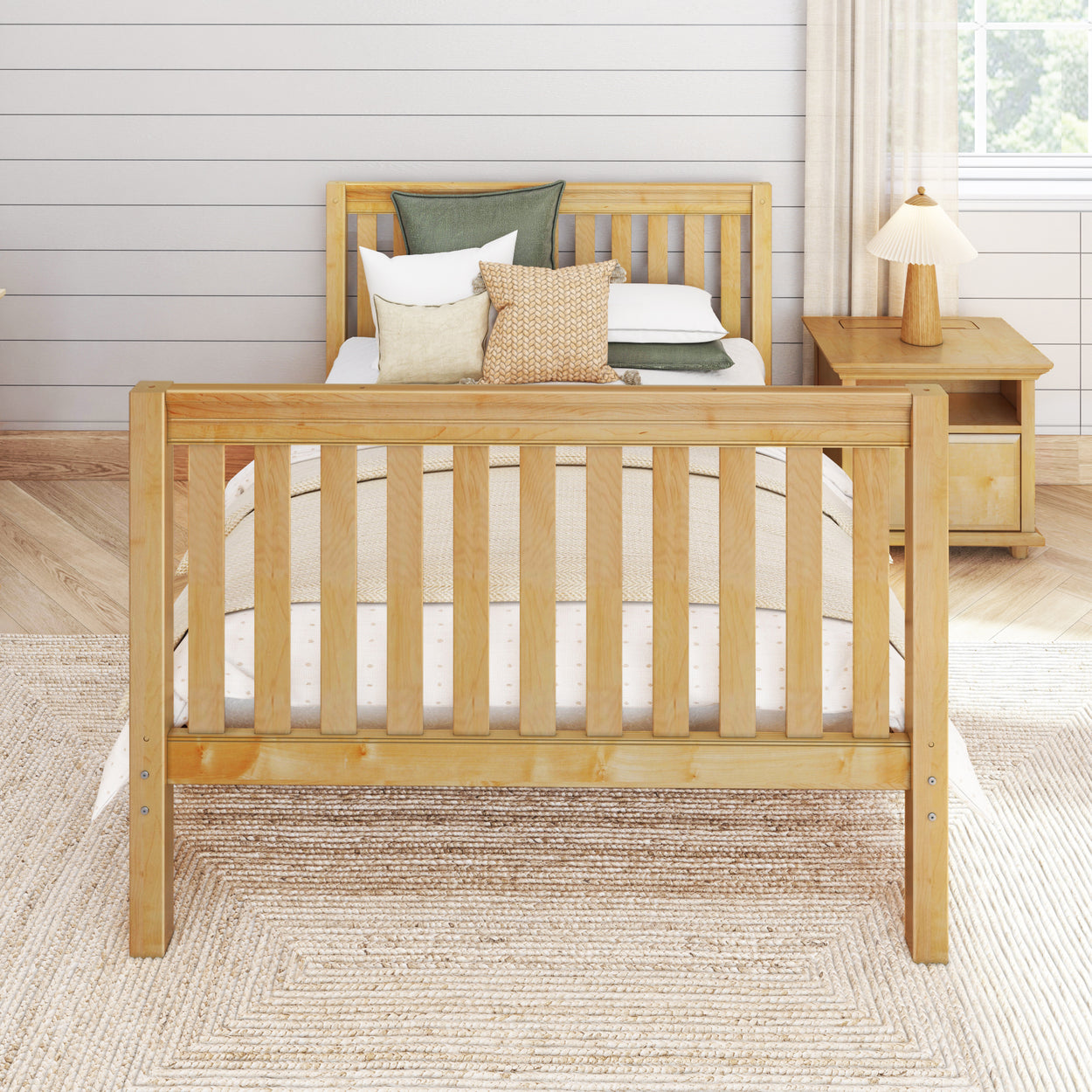 Wooden bed frame with cozy pillows and nightstand in modern bedroom.