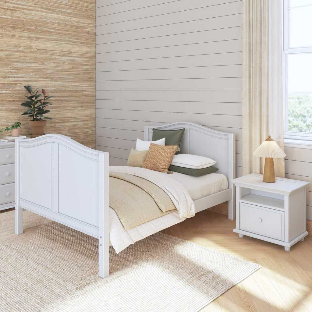 Cozy modern bedroom interior with white bed, wooden nightstand, and stylish decor elements.
