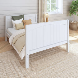 White wooden bed frame in cozy bedroom with neutral decor and natural light.