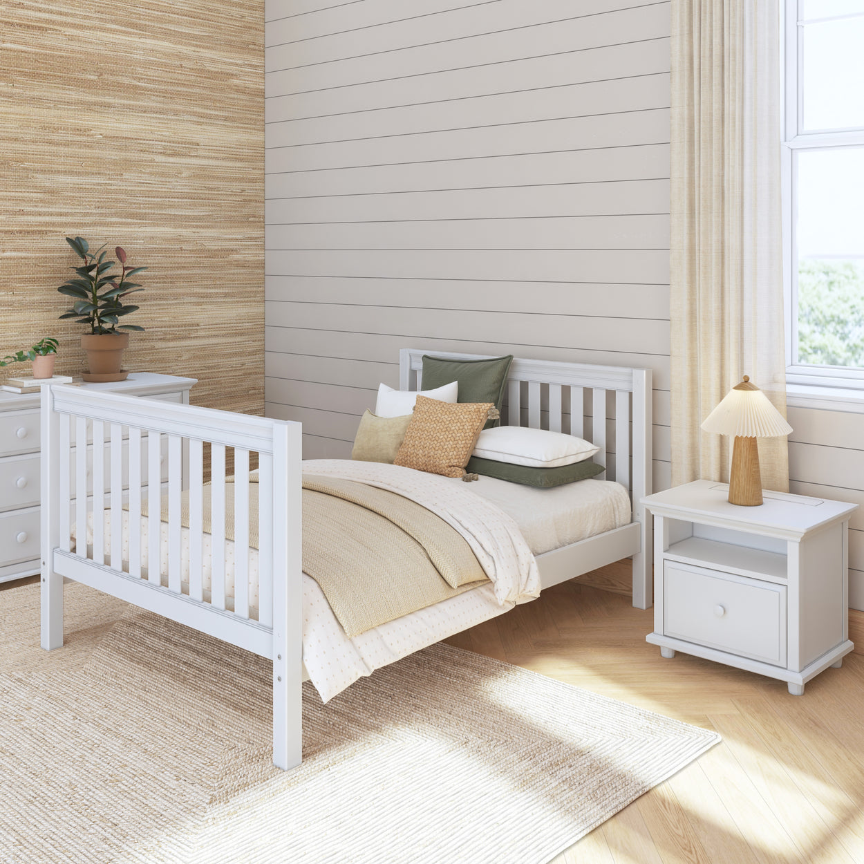 Stylish modern bedroom with white furniture, cozy bedding, and natural light.