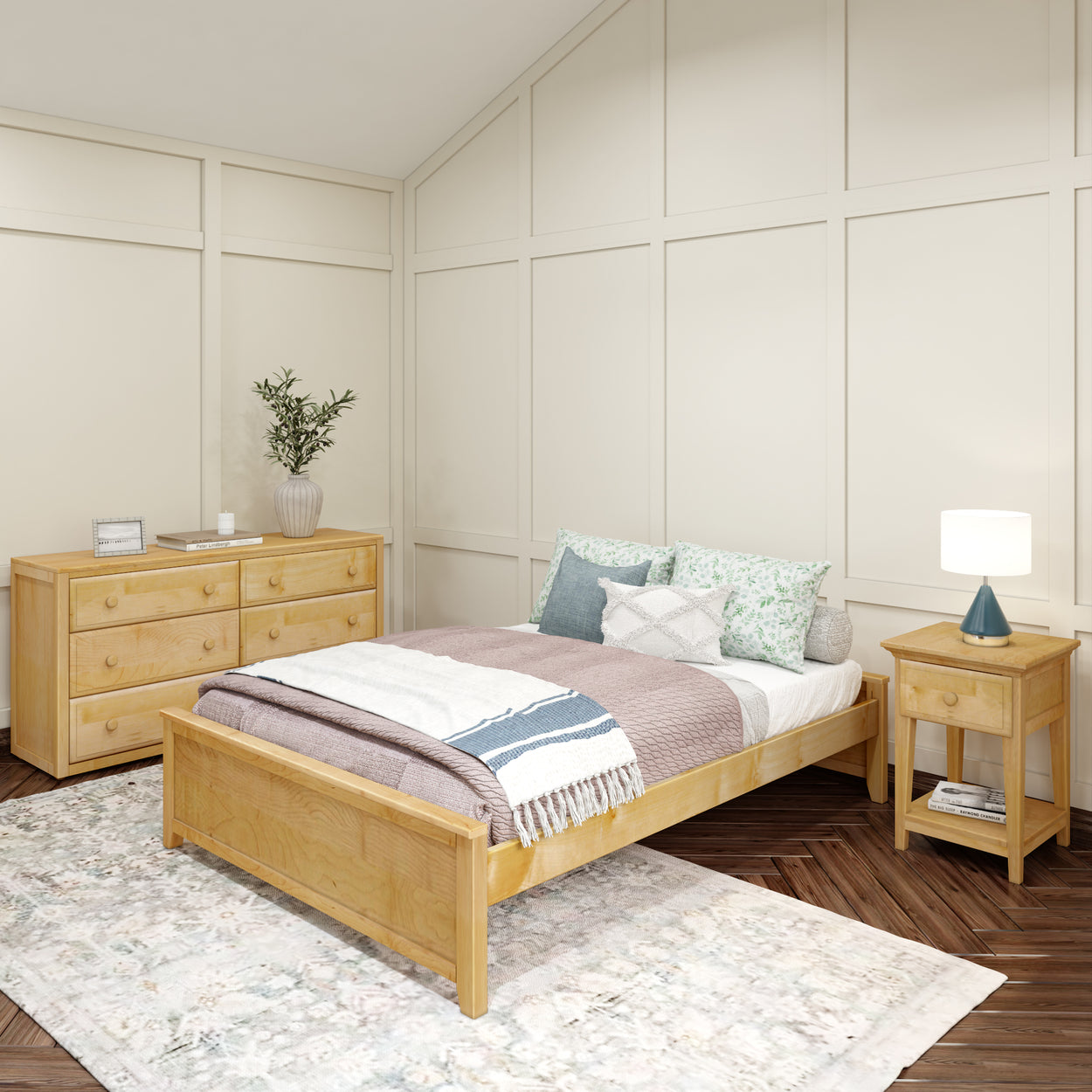 Cozy bedroom with modern wooden furniture, including a bed, dresser, and nightstand, accented by neutral decor and a soft area rug.
