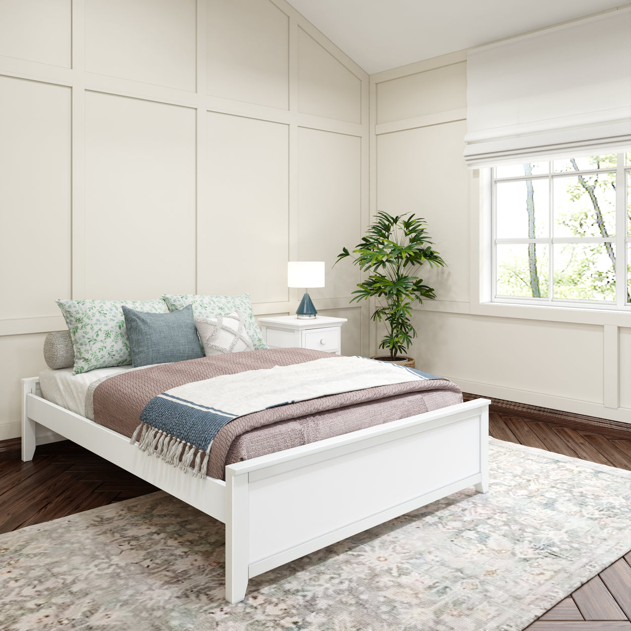 Cozy modern bedroom with white bed, decorative pillows, nightstand, lamp, potted plant, and large window.