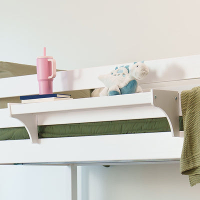White bunk bed shelf in children's bedroom with green bedding, blue dinosaur plush toy, pink insulated tumbler and stacked books.