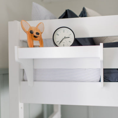Wooden dog shelf decor and alarm clock on white bunk bed.