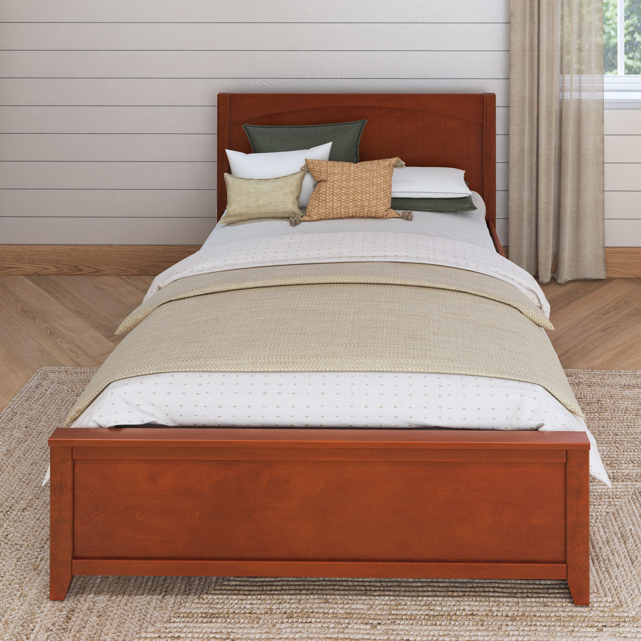 Wooden single bed with neatly arranged pillows and beige bedding in a cozy, modern bedroom setting.