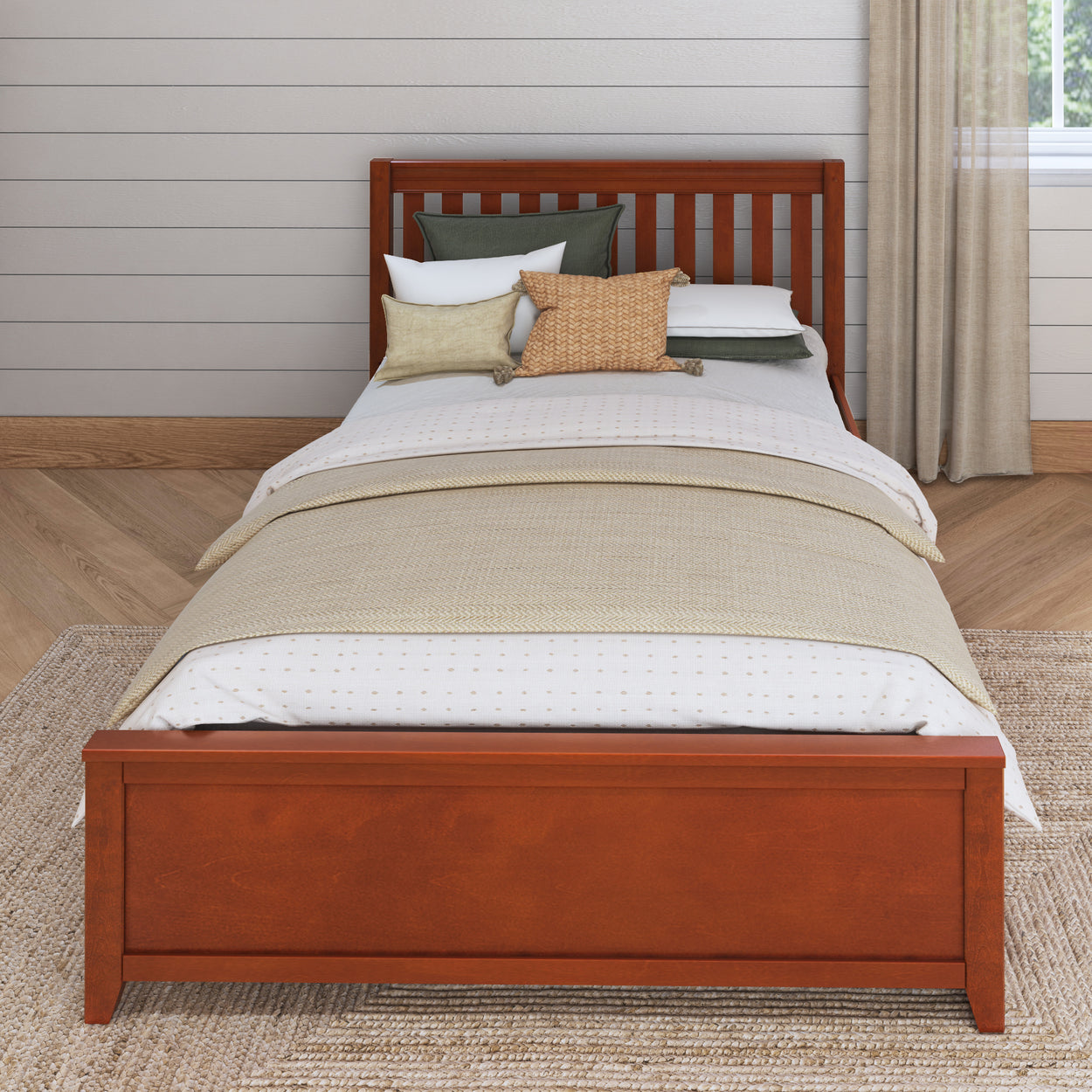 Wooden bed with striped bedding and decorative pillows in a modern bedroom setting.