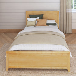Wooden bed frame with beige bedding and decorative pillows in a cozy bedroom.