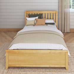 Wooden bed frame with neutral bedding and cushions in a cozy bedroom setting.