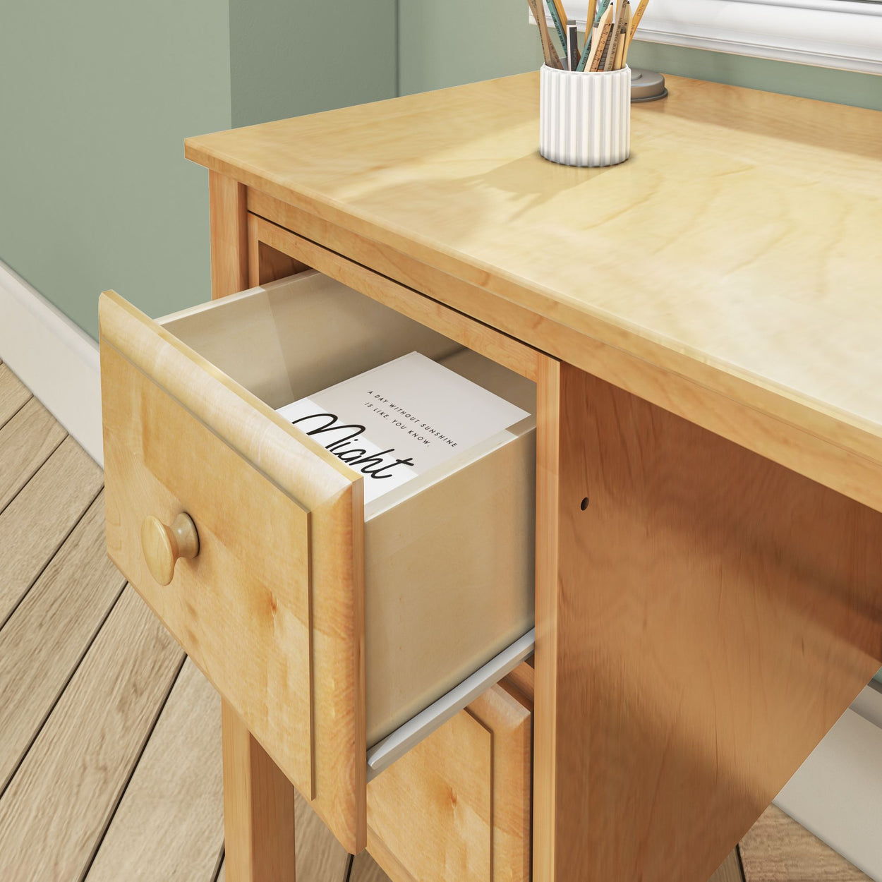 Wooden desk with open drawer revealing a document and pencil holder on top.