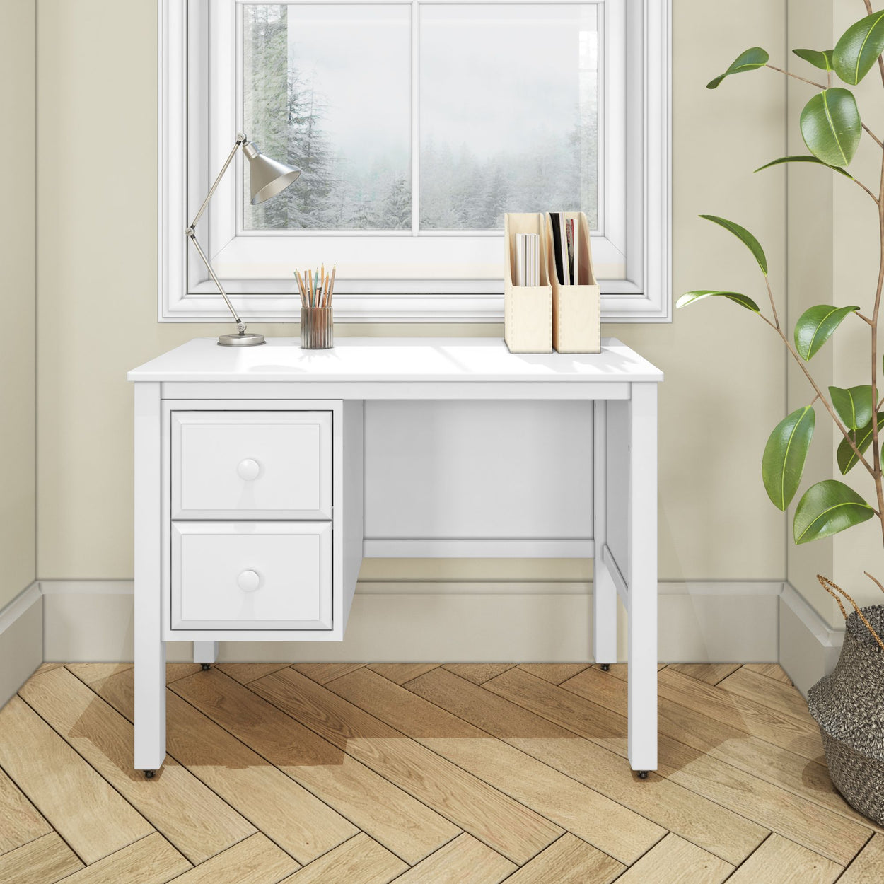 White modern desk with drawers in a home office setting, featuring a lamp, pencil holder, and file organizer near a window with a scenic view.
