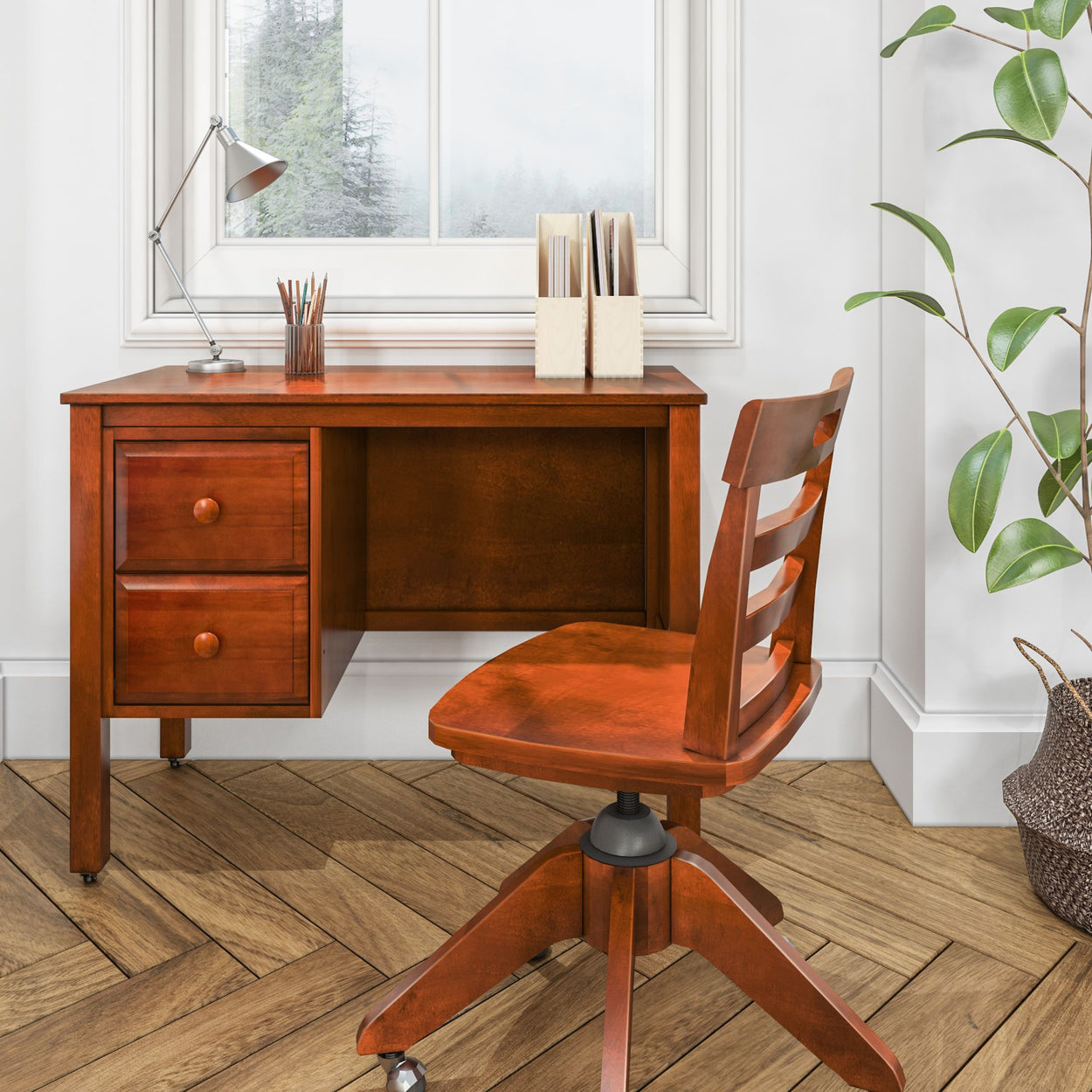 Wooden office desk and chair in a bright room with a window and green potted plant.