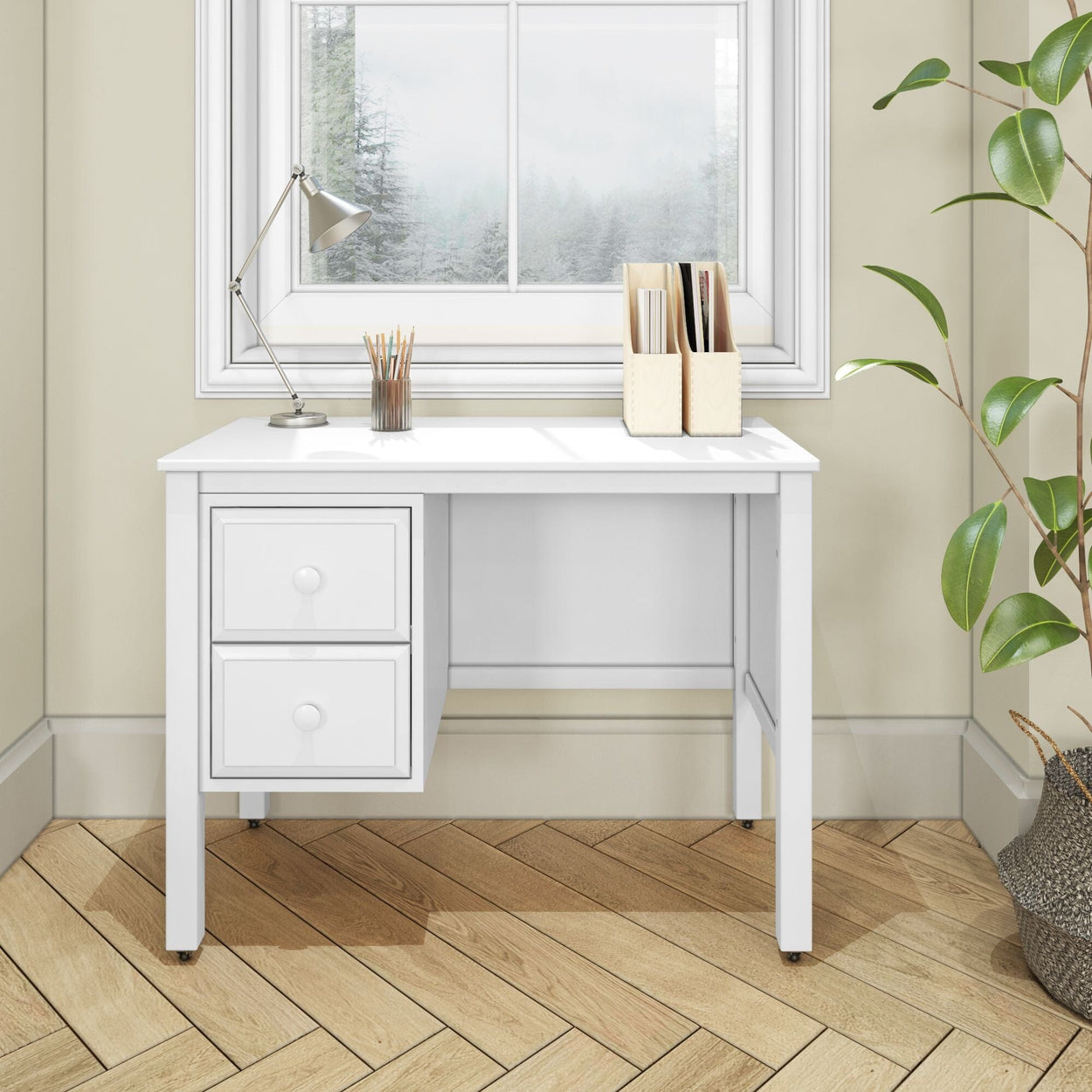 White modern desk with drawers in a home office setting, featuring a lamp, pencil holder, and file organizer near a window with a scenic view.