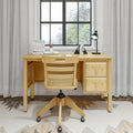 Wooden home office desk with chair, books, and lamp in front of window, ideal for modern productivity setup.
