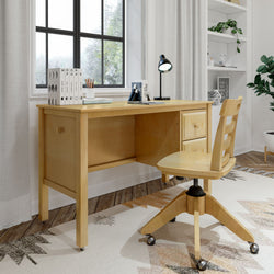 Modern home office setup with a wooden desk, swivel chair, and decorative elements like books and a desk lamp near a window.