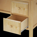 Open wooden drawer of a light-colored dresser, showcasing craftsmanship and storage space.