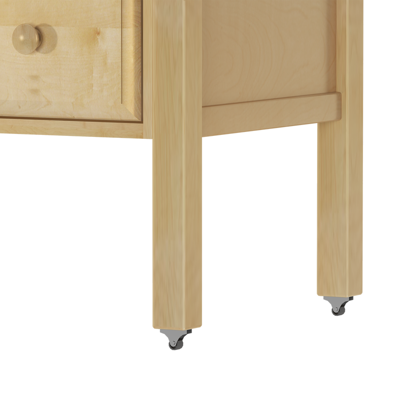 Close-up of natural maple wood cabinet legs with metal swivel caster wheels and lower drawer corner