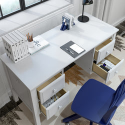 Modern white office desk with drawers, blue chair, and stationery set in a well-lit home workspace.