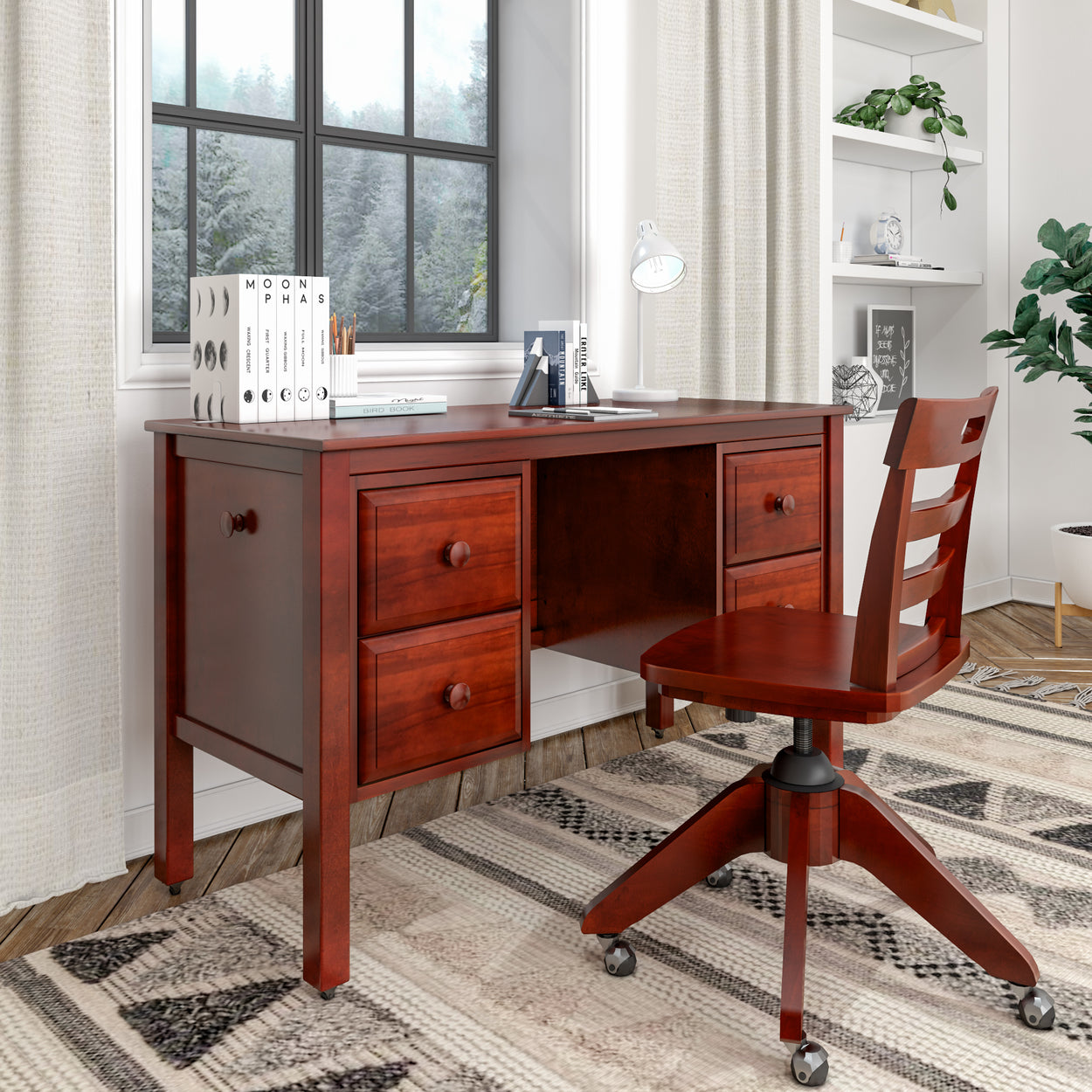 Wooden office desk and chair in cozy home office setup with books, lamp, and window view.