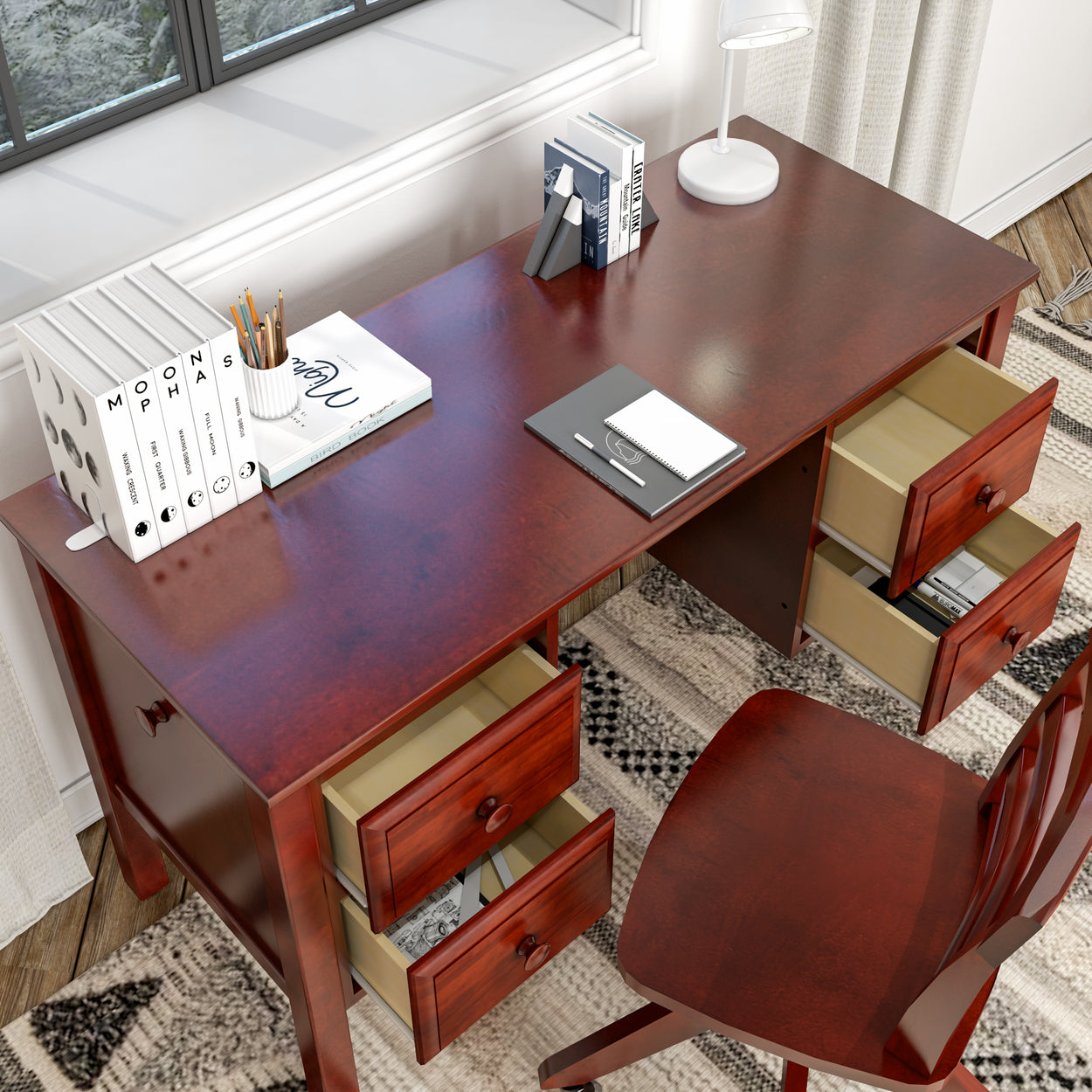 Vintage wooden office desk with open drawers and books, ideal for home study or workspace.