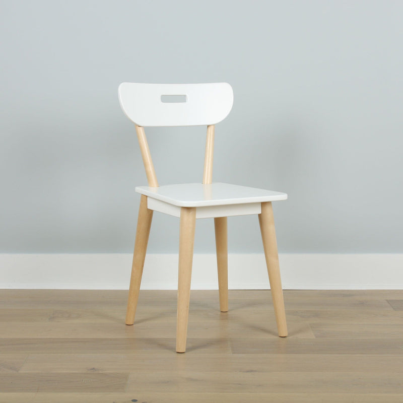 Minimalist white Scandinavian dining chair with light wood legs and handle-style cutout backrest against a pale gray wall