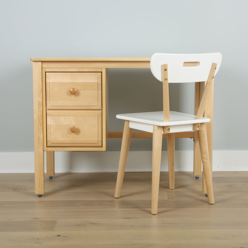 Minimalist light-wood study desk with drawers and white chair against pale blue wall
