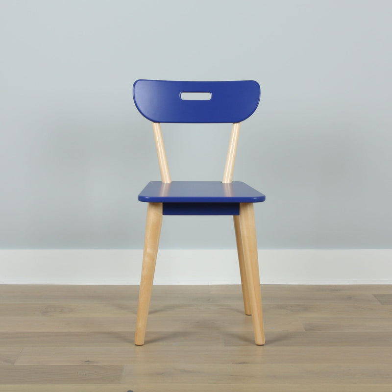 Minimalist blue chair with light wooden legs on hardwood floor against a pale blue wall