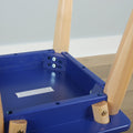 Close-up of blue wooden children's chair underside showing natural wood legs, metal bolts and screw fasteners at the assembly joint