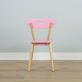 Pink modern wooden chair with natural wood legs, back view against pale blue wall on light hardwood floor
