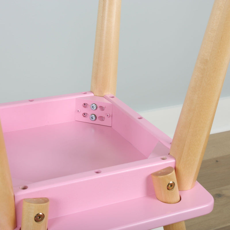 Close-up of pink wooden kids' chair showing natural wood legs, metal screws and assembly hardware