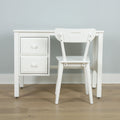 Minimalist white desk with drawers and matching white chair in a modern home office against a light gray wall on wood floor