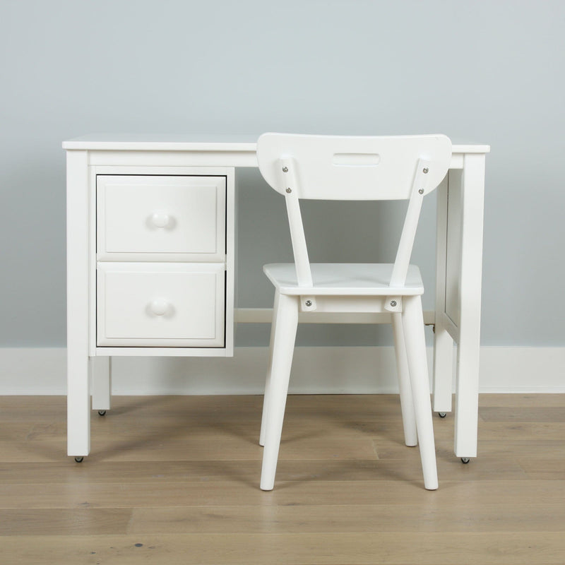 Minimalist white desk with drawers and matching white chair in a modern home office against a light gray wall on wood floor