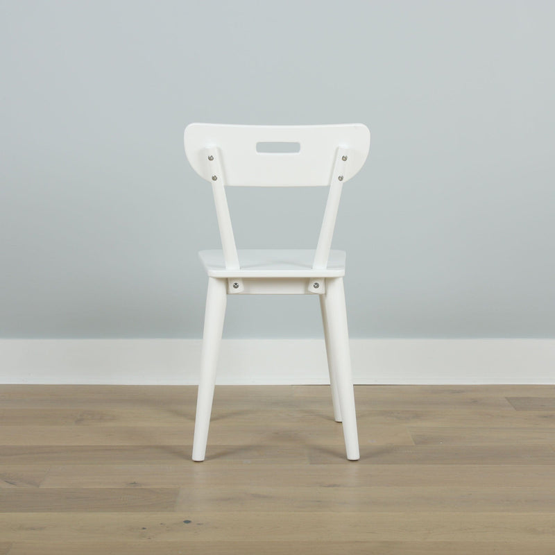 Minimal white dining chair back in a Scandinavian-style modern interior on light oak floor against a pale gray wall