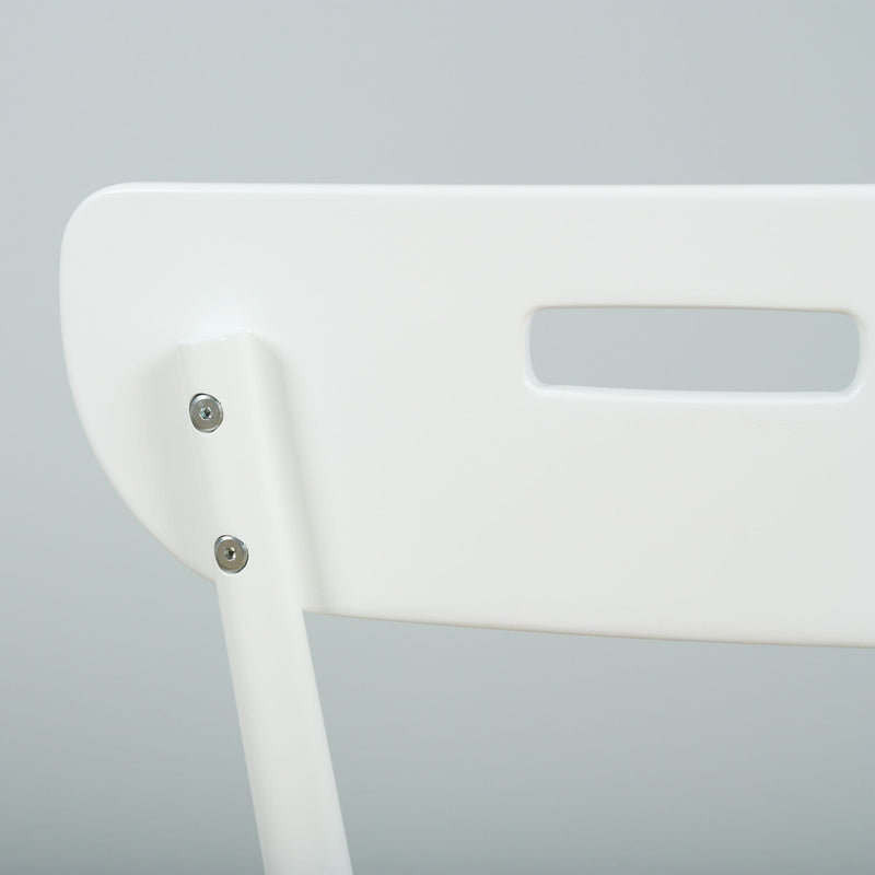 Close-up of white plastic chair back showing screws and rectangular handle cutout, minimalist modern dining chair detail on a soft grey background