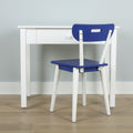 Minimalist white study desk with a blue chair on light wood floor against a pale gray wall