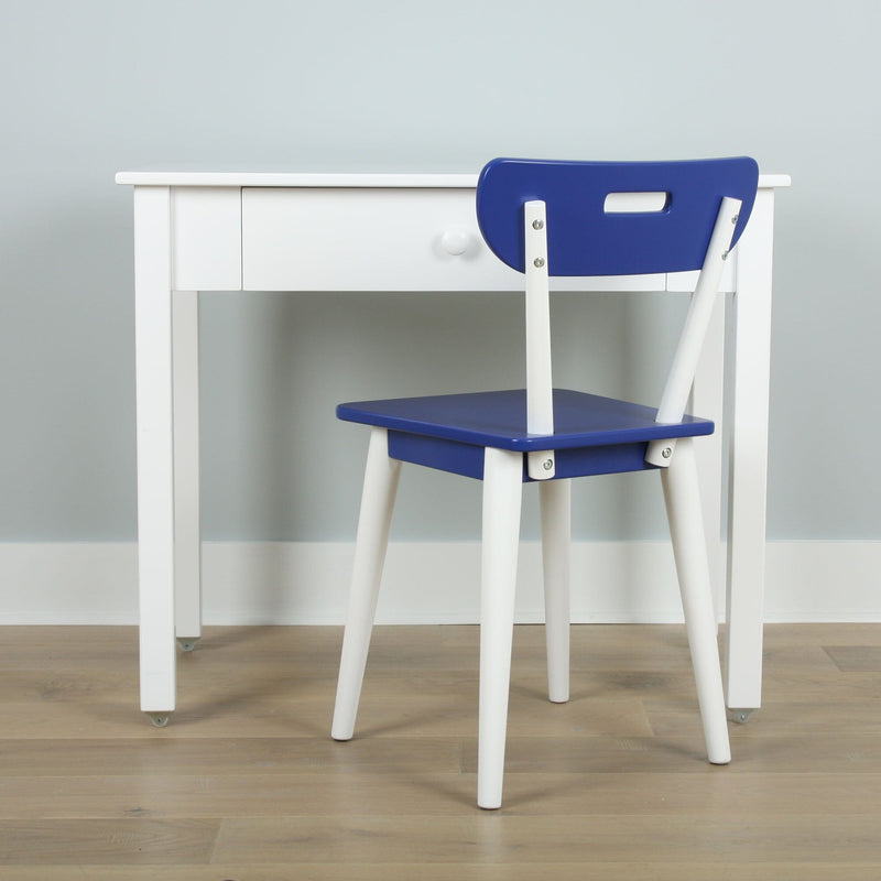 Minimalist white study desk with a blue chair on light wood floor against a pale gray wall