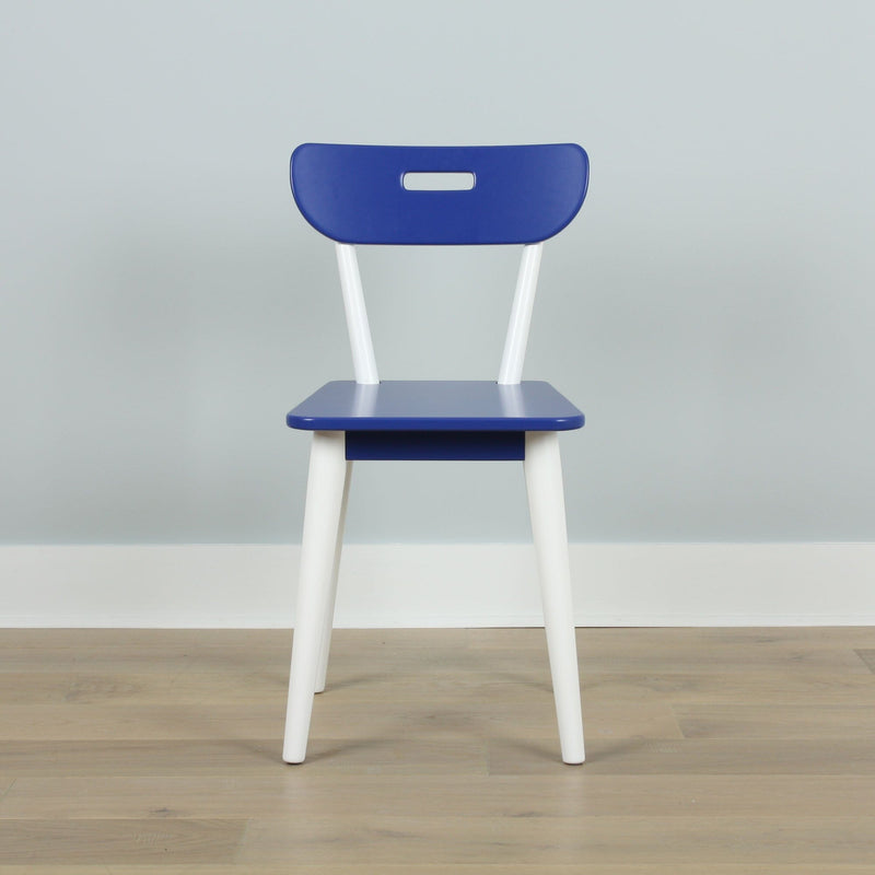 Modern blue dining chair with white angled legs and cutout backrest on light wood floor in minimalist interior